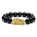 Detail shot of a men's black obsidian bead bracelet featuring a gold Pi Xiu mythical charm. - Style 2 / 12mm