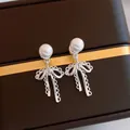 Elegant silver bow earrings with white pearls in a classic French retro style - Beige (925 Sterling Silver Earring Post)