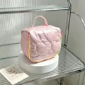 Detailed close-up view of the quilted heart pattern on this pink cosmetic wash bag - 14.5*8.5*14.5cm / Light Pink