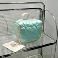 Mint green heart-quilted cosmetic bag featuring a pink handle and vibrant colorful zippers - 14.5*8.5*14.5cm / Cyan