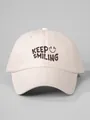 Close-up of a beige baseball cap featuring a 'Keep Smiling' print and smiley face - One Size / Beige