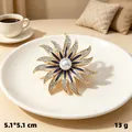 Vintage eight-pointed star brooch with blue enamel, white rhinestones and pearl inlay - KC Gold Sunflower