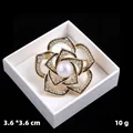 Vintage gold-tone flower brooch with a central pearl and sparkling clear rhinestones - KC Gold Enamel Camellia