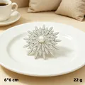 Vintage silver starburst brooch with rhinestones and central pearl on a white plate - Silver One Pearl Star