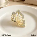 Elegant vintage golden butterfly brooch pin with sparkling rhinestones and cat-eye stones - Gold Butterfly Cat Eye