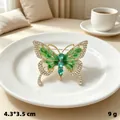 Elegant green butterfly brooch with rhinestones and enamel on white plate. - Gold Green Diamond Butterfly