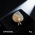 Elegant gold and silver leaf brooch with white pearl presented in a black velvet gift box - Two-Tone Leaf
