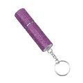 Detail view of a luxury pink rhinestone-covered perfume atomizer with a silver keychain. - Purple