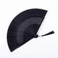Elegant black lacquered folding fan with a decorative tassel for classical Chinese dance - Small Window Hollow Black Satin Face