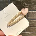 Elegant pearl hair clip with a shimmering pink heart accent for girls - Waterdrop Ice Heart / Pink