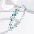 Elegant titanium steel spring bangle with alternating blue and clear square zircons - Light Blue