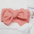 Detailed view of pink textured bubble fabric baby headband with large bow decor - Pink
