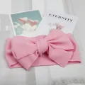 Close-up detail of soft pink textured baby headband featuring a beautiful oversized bow - Pink