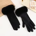 Detail view of black suede and PU leather winter gloves with plush faux fur cuffs. - Black