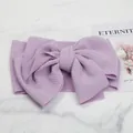 Close-up detail of a soft lavender textured bubble fabric bow headband for infants - Light Purple