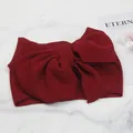 Detailed texture of a burgundy bubble fabric baby headband with a large bow - Burgundy