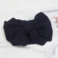 Close-up of a navy blue baby headband made of bubble texture fabric with a large bow detail - Navy Blue