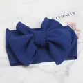 Detailed macro view of the dark blue textured corn grain fabric on a large bow baby headband - Sapphire Blue