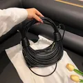 Elegant black noodle-style handbag with unique multi-layer circular handle design - Black