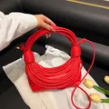 Unique red tubular woven handbag with a creative half-moon design and thin strap - Red