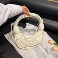Unique cream white noodle rope layered handbag with circular handle for summer 2025 - Off White