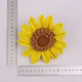 Handgefertigter gelber gestrickter Sonnenblumenanhänger mit Linealen zur Größenbestimmung - Einlagiger 14-Blütenblatt Sonnenblumenkopf / Gelb