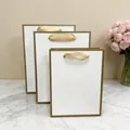 Elegant white paper gift bags with gold trim and ribbon handles in various sizes - (Vertical) 15L*6W*20H / White with Gold Edge