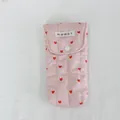 Detail of pink quilted heart pattern storage bag with button closure. - Quilted Striped Heart Pink