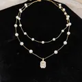 Elegant double-layered gold-plated necklace with white pearls and square crystal pendant - Gold White