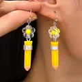 Handcrafted creative yellow pencil drop earrings with transparent flower bead detail - Flower Pencil Style / Silver