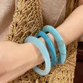 Elegant set of three blue resin bangles in teal and marble azure tones on model arm - 12# Bracelet - Blue (three-piece Set)