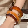 Stack of three amber and orange translucent chunky acrylic resin bangles shown on wrist - 13# Bracelet - Brown (three-piece Set)