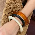 Stylish set of three chunky resin acrylic bangles in amber black and cream worn on wrist - 15# Bracelet - White - Black - Brown (three-piece Set)