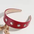 Serre-tête large en cuir PU rouge orné de rivets métalliques en forme de fleurs évidées. - Découpe Florale Rouge Vin