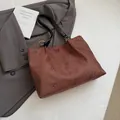 Brown faux suede tote bag featuring laser-cut floral patterns and contrast black handles - No Pendant / Brown