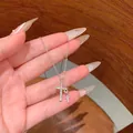 Close-up of silver-toned titanium steel double cross necklace with shimmering rhinestones - Silver Double Cross Pave Rhinestone Pendant (X2243) / Silver