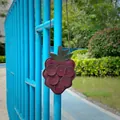 Detail view of the cute raspberry-shaped soft litchi grain leather bag for kids. - Grapes