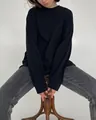 Detailopname van een oversized zwart katoenen dames-T-shirt met lange mouwen en boorden - M / Tops / Zwart