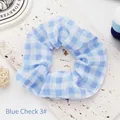 Close-up detail of a light blue gingham fabric scrunchie with soft and airy texture - Blue Plaid 3