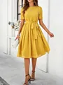 Full-length view of a vibrant yellow polka dot midi dress with an elegant waist tie. - S / Tops / Yellow