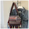 Detailed view of bohemian woven shoulder bag with colorful tassels and matching pouch - Two-Piece Set / Red