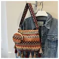 Detailed view of bohemian style shoulder bag with tassels and matching small coin purse - Two-Piece Set / Orange