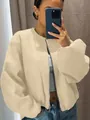 Detailed view of a soft apricot oversized bomber jacket with a silver metal zipper for women - XXS / Tops / Apricot