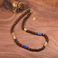 Detailed shot of retro coconut shell necklace with lapis lazuli and gold spacers. - Gold Style (2)