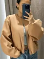 Close-up of camel-colored soft bomber jacket with silver zipper detail - XXS / Tops / Camel