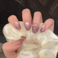 Close-up detail of purple ombré pearlescent short oval press-on nails with 3D bow charm - By2200 / Handmade Nail Art Size M 10 Pieces/bag [tool Kit Included]