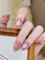 Short oval nude pearlescent press-on nails featuring elegant white floral glitter design - By2054 / Handmade Nail Art Size M 10 Pieces/bag [tool Kit Included]