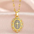 Detailed view of a vintage gold cross pendant with intricate borders on pink silk. - PJ213046-GN