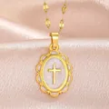 Close-up of a vintage gold-plated cross pendant featuring a textured oval medallion - PJ213046-GY