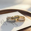 Close-up of three vintage-style rings featuring blue sapphires and white diamond stones. - Adjustable Open / Champagne Gold (Blue Rhinestone)